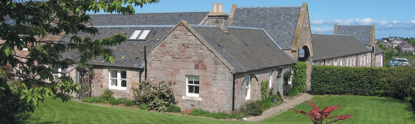 Stone steading holiday cottages with arched carriage-house windows