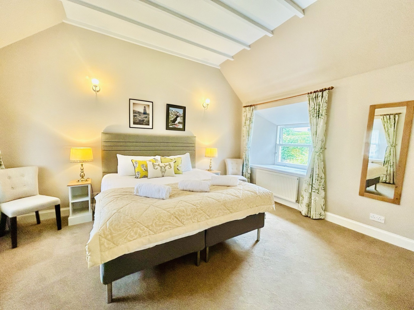 A bright cottage bedroom with a made-up double bed