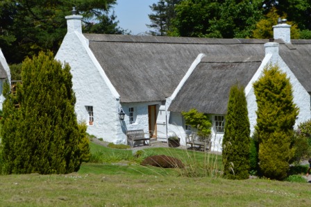 White thatched cottages of Swanston Village among the trees
